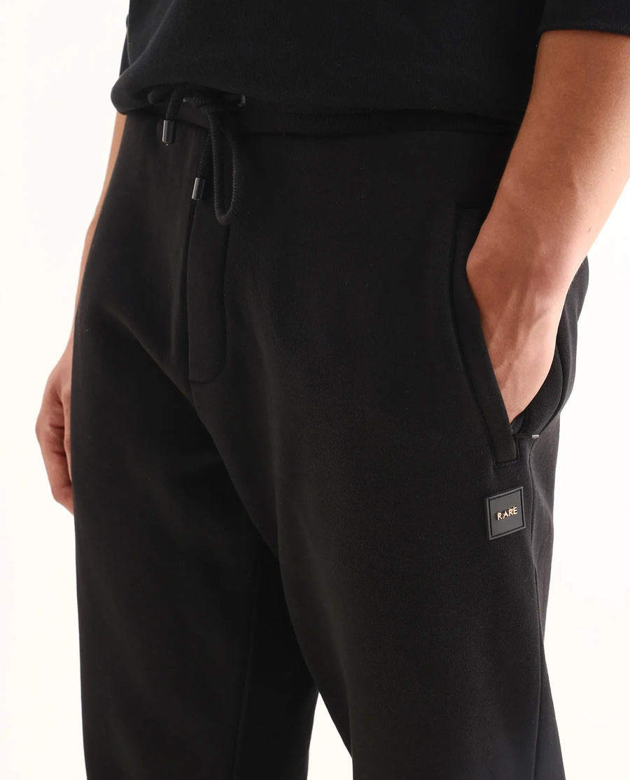Rare Rabbit Men's Anderson-B25 Black Cotton Blend Fabric Badge Print Joggers